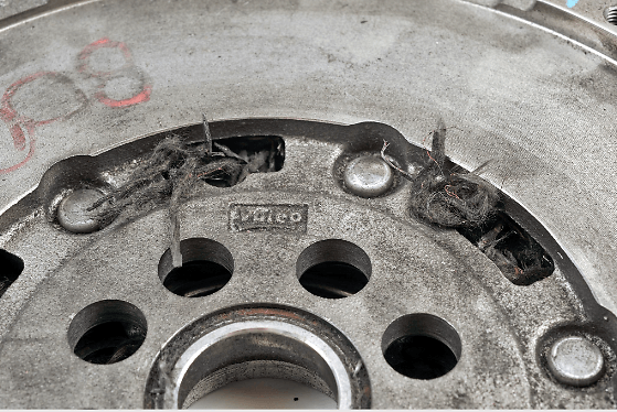 Burnt residues of abraded lining inside ventilation holes.