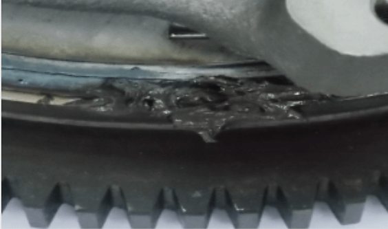 Trace of liquid or solid grease from primary flywheel welding.