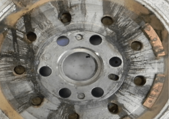 Excessive trace of grease on the back of the primary flywheel.
